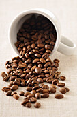 Close-up of Coffee Beans Spilling out of Mug