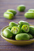 Close-up of Bowl of Mini Kiwi with One Cut in Half