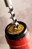 Close-up of Corkscrew Opening Bottle of Wine