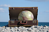 Globe in Suitcase on Rocky Beach,Frontignan,Herault,France