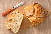 Overhead View of Bread on Cutting Board with Knife