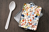 Overhead View of Tablets in Metal Box with Spoon,Studio Shot