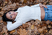 Woman Lying Down in Autumn Leaves