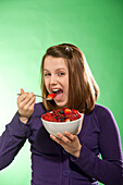 Teenage Girl Eating Bowl of Berries