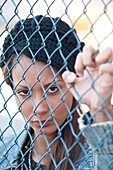 Portrait of Woman behind Fence