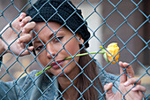 Portrait of Woman behind Fence