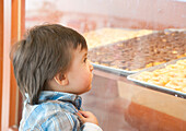 Boy Looking in Bakery Window,Mexico
