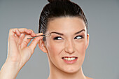 Woman Plucking Eyebrows