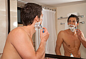 Mann rasiert sich im Hotelzimmer,Reef Playacar Resort and Spa,Playa del Carmen,Mexiko
