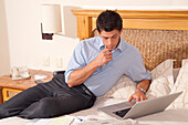 Man using Laptop in Hotel Room,Reef Playacar Resort and Spa,Playa del Carmen,Mexico