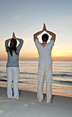 Couple doing Yoga on Beach,Reef Playacar Resort and Spa,Playa del Carmen,Mexico