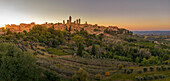 Elevated view of San Gimignano and town at sunset,San Gimignano,Tuscany,Italy,Europe