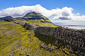 One person hikes the ridge toward the Skaelingsfjall mountain,Streymoy island,Faroe islands,Denmark,Europe