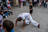 Members of Mestre Branco Capoeira Escola demonstrate in the street during the Fiestas of El Pilar in Zaragoza,Aragon,Spain