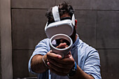 Young man playing with Meta Quest 2 all-in-one VR headset during ZGamer,a festival of video games,digital entertainment,board games and YouTubers during El Pilar Fiestas in Zaragoza,Aragon,Spain