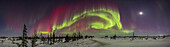 A 220° panorama of a colourful aurora on a Kp6 night on February 26,2023,from the Churchill Northern Studies Centre,Churchill,Manitoba,at 58° N. This is mostly looking south over the old Rocket Range,with the waxing Moon prominent at right in Taurus near the Pleiades and above Orion. Moonlight illuminates the foreground.
