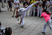 Members of Mestre Branco Capoeira Escola demonstrate in the street during the Fiestas of El Pilar in Zaragoza,Aragon,Spain