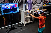 Young boy playing with Meta Quest 2 all-in-one VR headset during ZGamer,a festival of video games,digital entertainment,board games and YouTubers during El Pilar Fiestas in Zaragoza,Aragon,Spain