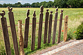 Garden decoration - wooden fence with carved figures