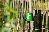 Garden decoration - Painted clay pot on fence