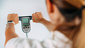 Woman using body composition scales
