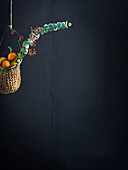 Hanging basket with mandarins and eucalyptus branch
