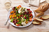 Summer salad with cherries, peaches, mozzarella and ciabatta