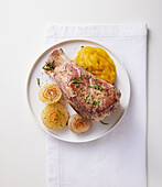 Pork knuckle with sweet potato puree and caramelised onions