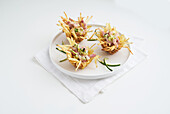 Deep-fried potato baskets filled with bacon and courgette