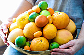 Woman holding peel with citrus fruit