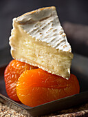A slice of Camembert on dried apricots