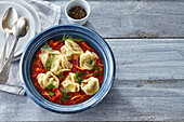 Uzbek pelmeni in tomato sauce