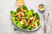 Crispy avocado salad with olive oil and bacon dressing