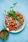 Sweet potato and gnocchi salad with feta, rocket and red onions