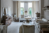 Living room in shabby chic style with light-coloured wooden furniture and rustic accessories