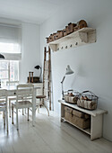 Vintage-style dining room with white wooden furniture and decorative elements made of metal and wood