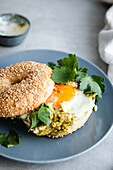 Bagel with avocado and fried egg