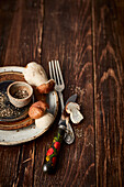 Autumnal, rustic table setting with fresh porcini mushrooms and coarsely crushed pepper