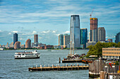 Tourist pleasure craft Miss Freedom of the Statue Cruises line passes lower Manhattan in New York Harbor