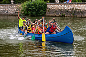 Young people practicing canoeing on rio Tajo river or Tagus river in the La Isla garden Aranjuez Spain.