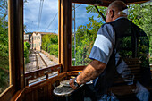 Fahrer der historischen Straßenbahn im Dorf Soller. Die Straßenbahn verkehrt auf einer Strecke von 5 km vom Bahnhof im Dorf Soller zum Puerto de Soller, Soller Mallorca, Balearen, Spanien, Mittelmeer, Europa