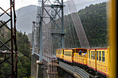 Petit train jaune train in the suspension bridge at Pont Gisclard bridge between Sauto and Planès, France.