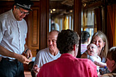 Inspector and passengers inside the Strawberry train that goes from Madrid Delicias train station to Aranjuez city Madrid, Spain.