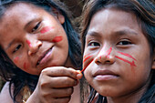 Tattoo painting, Yagua Indians living a traditional life near the Amazonian city of Iquitos, Peru.