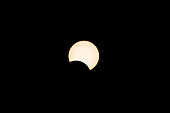 The moon moves across the front of the sun after the peak of the annular solar eclipse on 14 November 2023. Utah, USA. One hour after peak annularity.