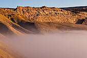 Morrison Formastion sandstone above early morning fog in Dinosaur National Monument near Jesnse, Utah.