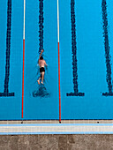 Aerial photo of a man swimming in an outdoors pool