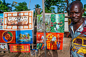 Local painter selling souvenirs in the Las Terrenas city center Samana, Dominican Republic, Carribean, America.