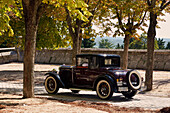 A classic car on the road in a car festival in San Lorenzo de El Escorial, Madrid.