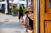 Asian tourist inside the vintage tram at the Port of Soller village center. The tram operates a 5kms service from the railway station in the Soller village to the Puerto de Soller, Soller Majorca, Balearic Islands, Spain, Mediterranean, Europe.